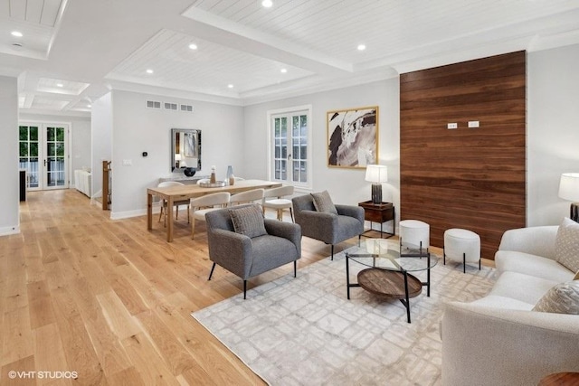 living room with beam ceiling, plenty of natural light, light wood-style flooring, and recessed lighting