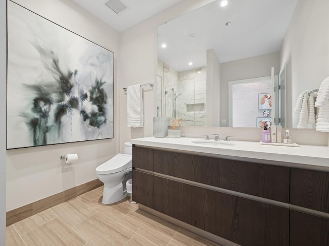 bathroom featuring visible vents, baseboards, toilet, a stall shower, and vanity