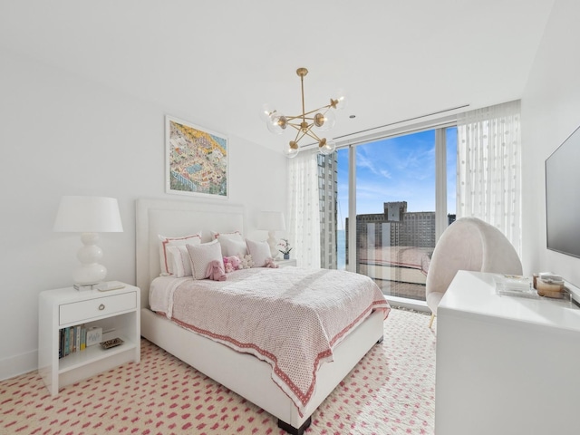 bedroom featuring access to exterior, floor to ceiling windows, light colored carpet, and an inviting chandelier