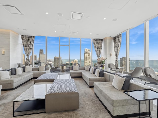 living room featuring a wall of windows, a city view, and a wealth of natural light