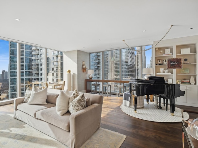 living room featuring a city view, a wall of windows, and wood finished floors