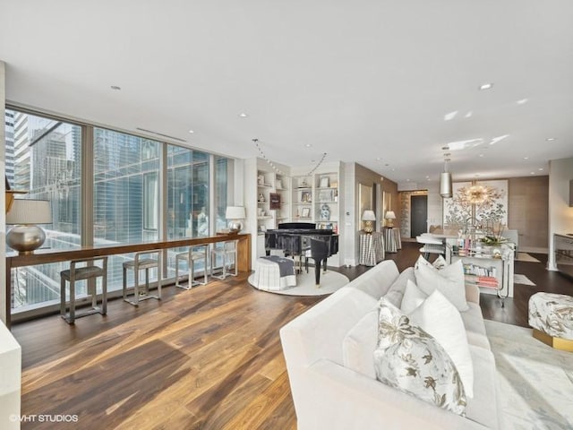 living room with a notable chandelier and wood finished floors