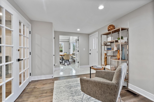 living area featuring recessed lighting, french doors, visible vents, and baseboards