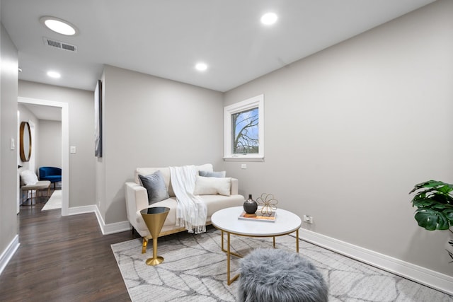 living area with recessed lighting, dark wood finished floors, visible vents, and baseboards