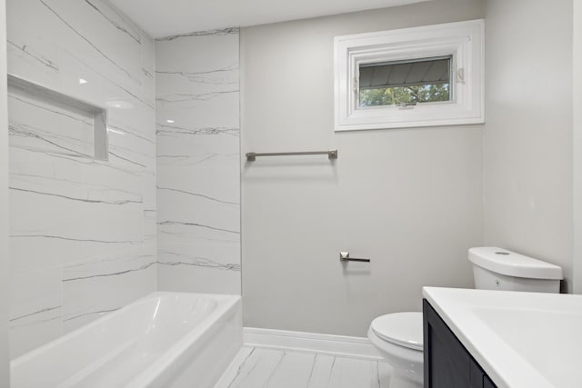 bathroom featuring marble finish floor, shower / bathing tub combination, toilet, vanity, and baseboards