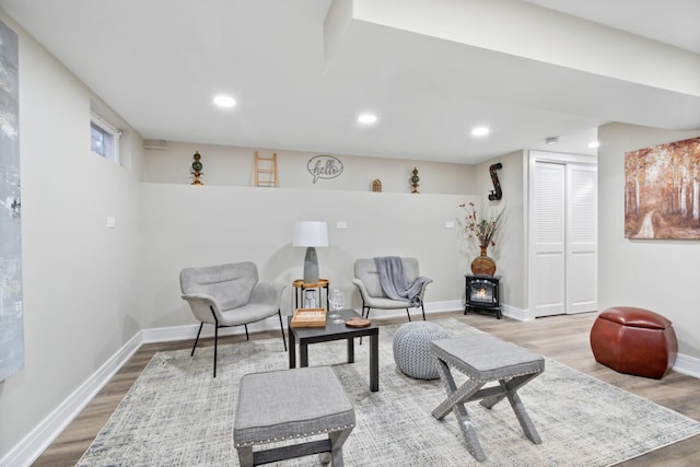 living area with light wood finished floors, recessed lighting, and baseboards