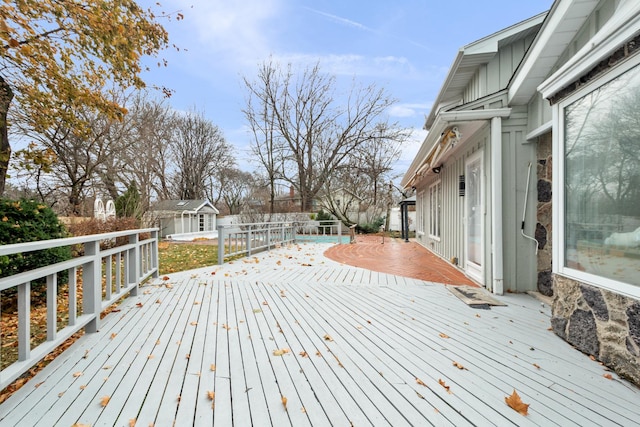 deck with an outbuilding and a storage unit