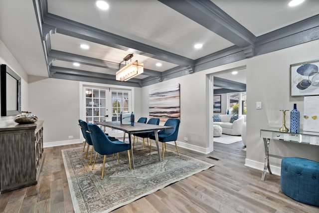 dining space featuring french doors, beamed ceiling, baseboards, and wood finished floors