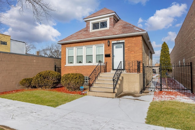 view of front facade with fence and brick siding