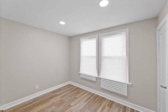 unfurnished room featuring light wood-style floors, baseboards, and recessed lighting