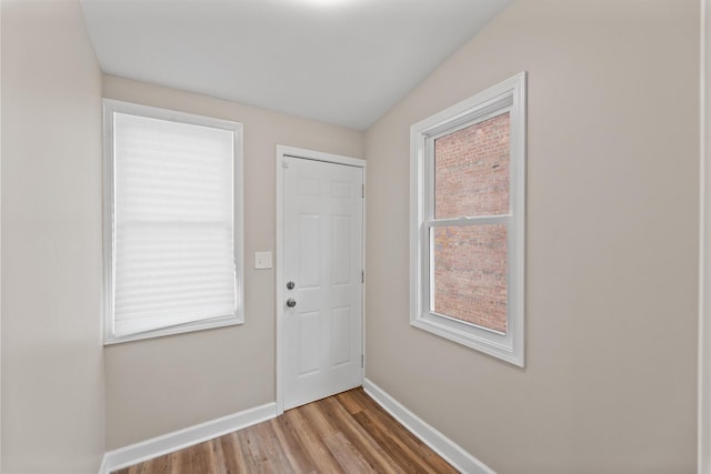 entryway with light wood finished floors and baseboards