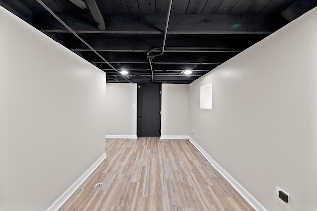 finished basement featuring wood finished floors and baseboards