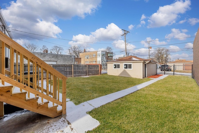 view of yard featuring a fenced backyard, stairway, and an outdoor structure