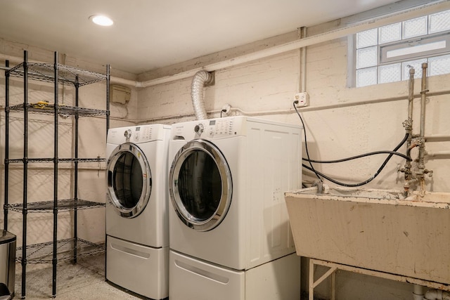 laundry room with a sink, laundry area, and washing machine and clothes dryer