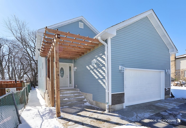 view of front of property featuring a garage and fence