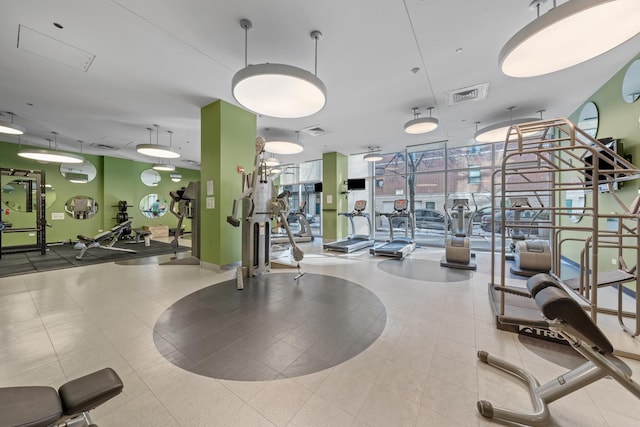 workout area featuring a wall of windows and visible vents