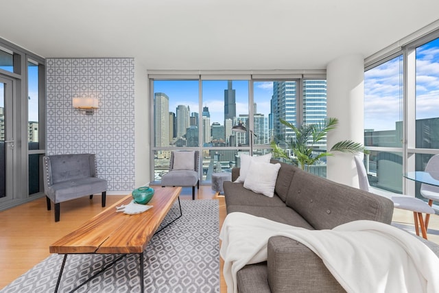 living room featuring expansive windows, a city view, and wood finished floors