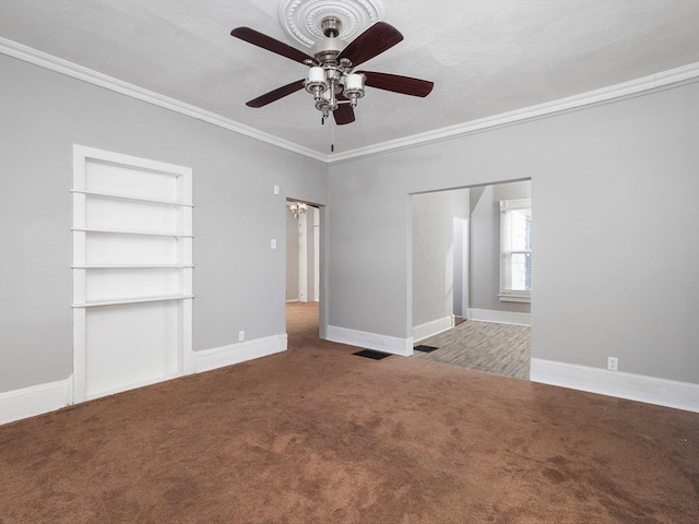 unfurnished bedroom featuring baseboards, carpet floors, visible vents, and crown molding