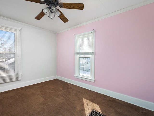 carpeted empty room with baseboards, visible vents, ornamental molding, and a ceiling fan