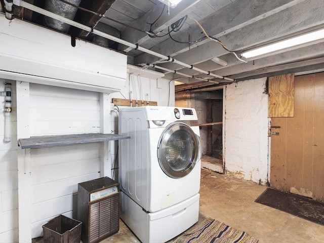 washroom with laundry area, washer / clothes dryer, and wood walls