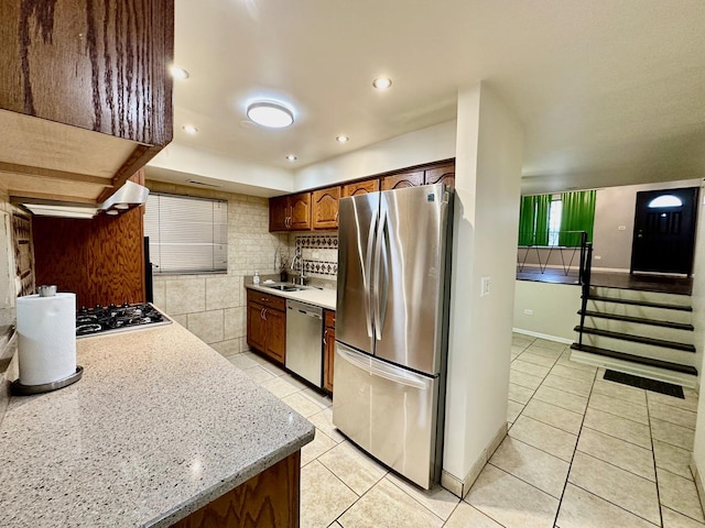 9310 S Eggleston Ave, Chicago, IL 60620 - kitchen featuring stainless steel appliances, a sink, light tile patterned floors, and tasteful backsplash