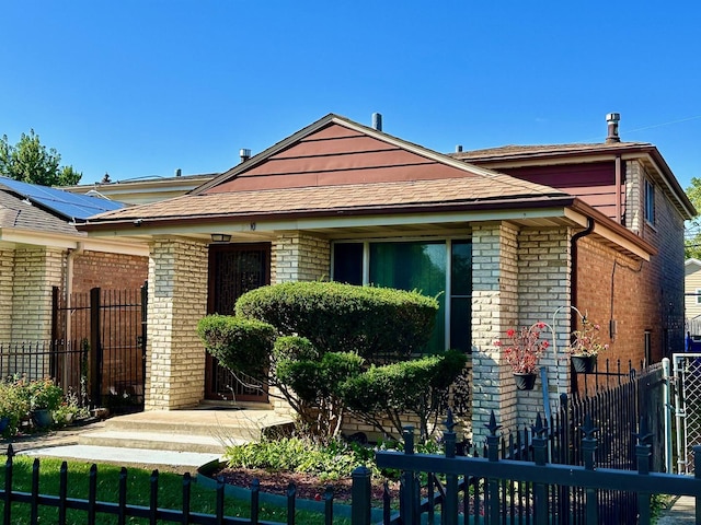 view of front of house featuring a fenced front yard and brick siding