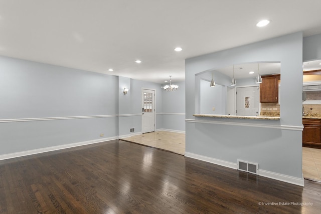 unfurnished living room with recessed lighting, visible vents, and wood finished floors