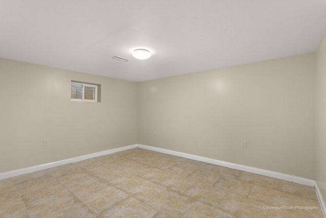 spare room featuring visible vents and baseboards