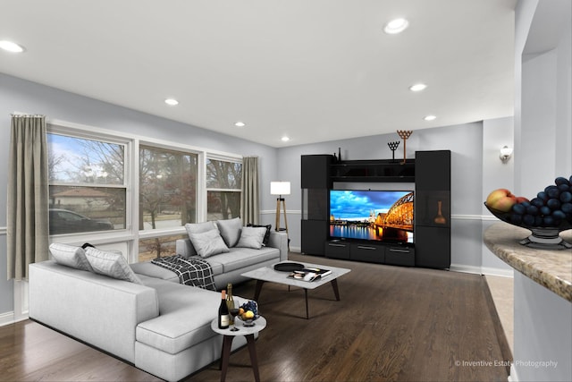 living room with baseboards, wood finished floors, and recessed lighting