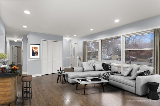 living room with baseboards, dark wood finished floors, and recessed lighting