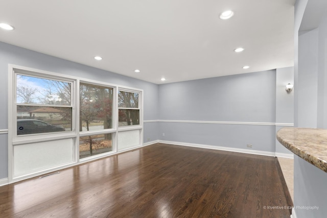 interior space featuring recessed lighting, wood finished floors, visible vents, and baseboards