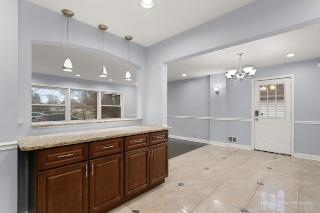 kitchen featuring hanging light fixtures, recessed lighting, visible vents, and baseboards