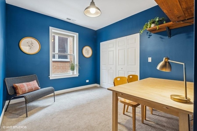 carpeted office space with baseboards and visible vents