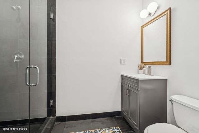 bathroom featuring baseboards, a shower stall, toilet, and vanity