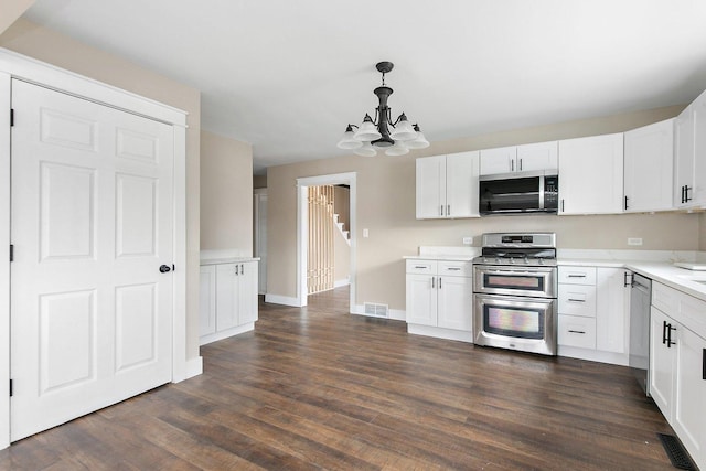 kitchen with visible vents, white cabinetry, light countertops, appliances with stainless steel finishes, and dark wood-style floors