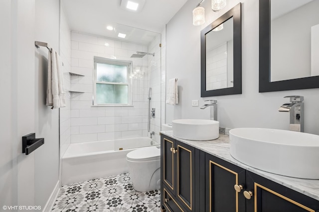 bathroom with toilet, double vanity, and shower / washtub combination