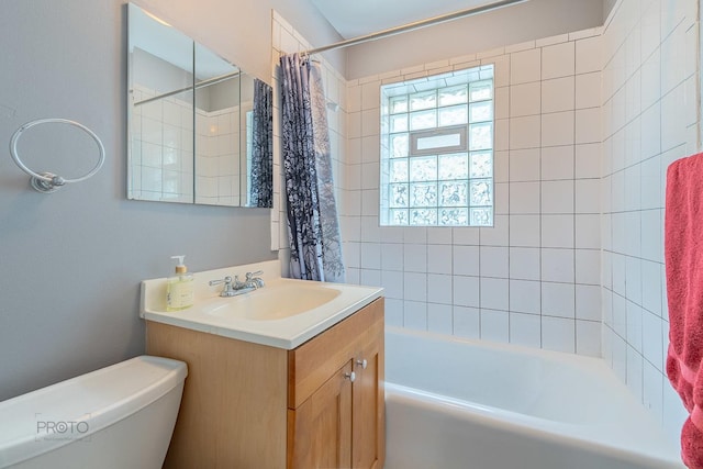 bathroom with toilet, shower / bath combo, and vanity