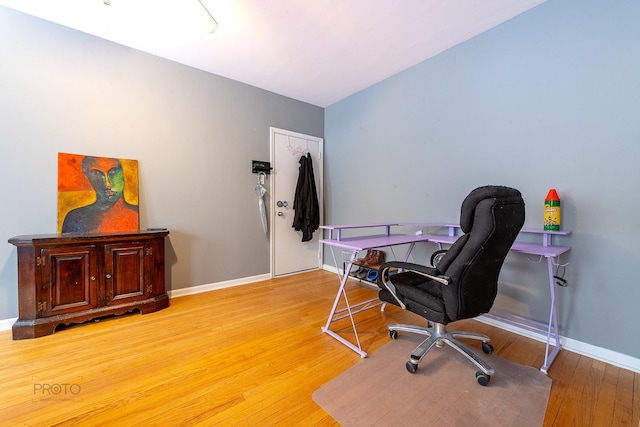 office area with light wood-style flooring and baseboards