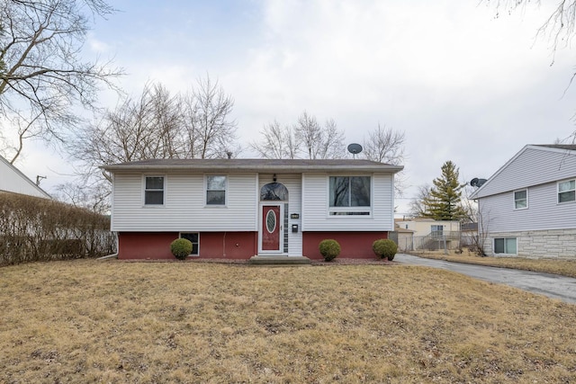 raised ranch with entry steps and a front lawn