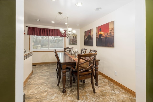 dining room featuring baseboards, stone finish flooring, recessed lighting, and an inviting chandelier