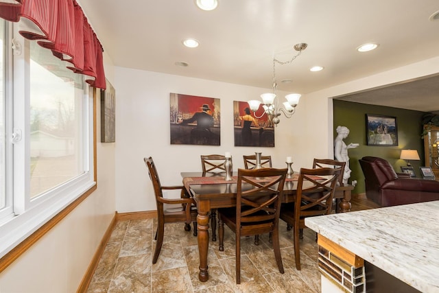 dining area with baseboards, a chandelier, and recessed lighting