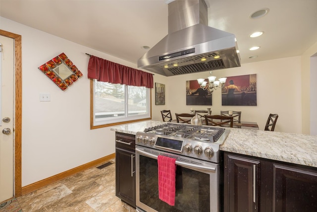 kitchen with baseboards, visible vents, light countertops, stainless steel range with gas stovetop, and exhaust hood