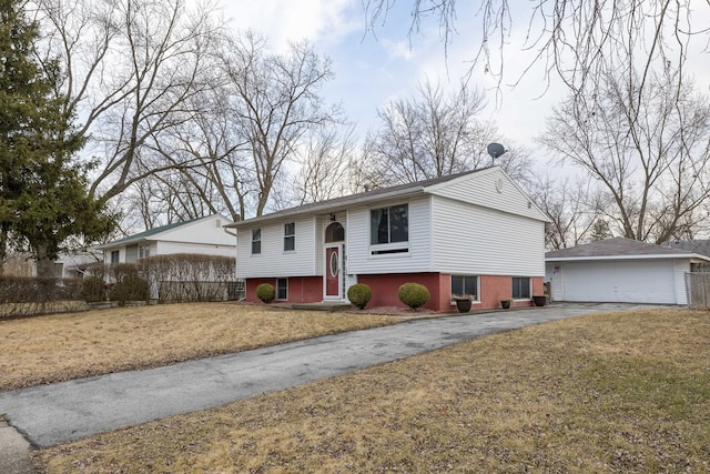 split foyer home featuring a garage, entry steps, an outdoor structure, and a front lawn