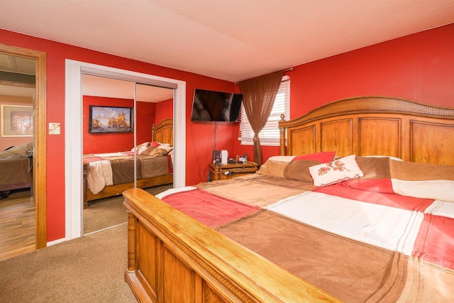 bedroom featuring a closet and light colored carpet