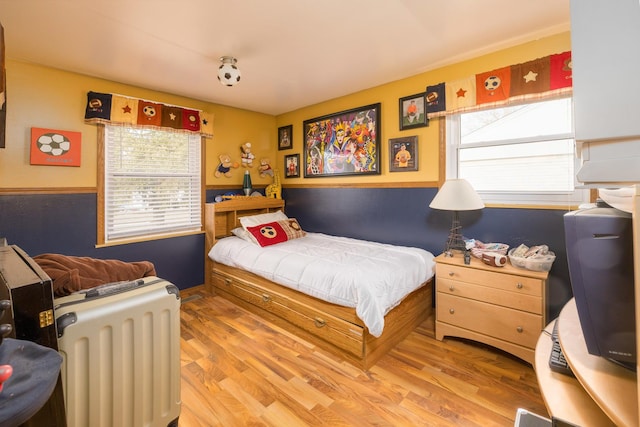 bedroom with light wood finished floors