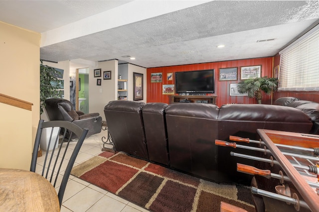 living room featuring wooden walls, recessed lighting, a textured ceiling, and tile patterned floors