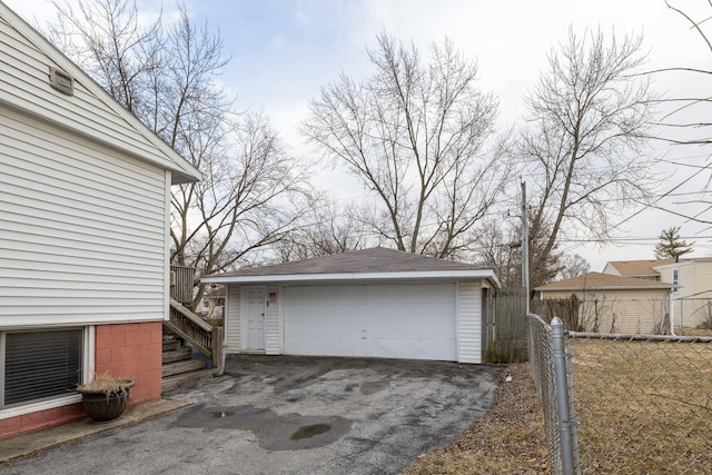 detached garage featuring fence