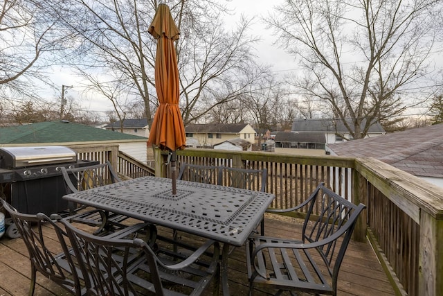 deck with a grill and outdoor dining area