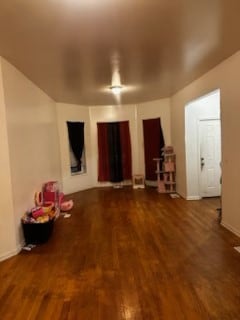 interior space featuring dark wood-style floors and baseboards