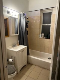 bathroom with vanity, shower / bathtub combination with curtain, toilet, and tile patterned floors